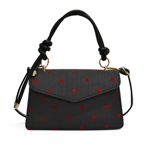 Minimalist grey crossbody bag with red polka dots and decorative bow handle details
