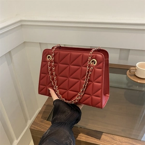 Deep red quilted shoulder bag with golden chain strap and triangle embroidery pattern