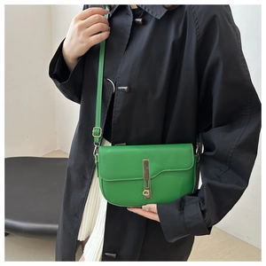Green minimalist saddle bag for women, crossbody style with golden metal buckle and smooth finish