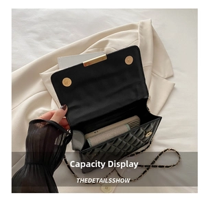 Internal view of black quilted crossbody bag showing capacity for phone and essentials