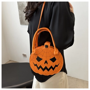 Fashionable pumpkin shoulder bag with spider web stitching and classic jack-o'-lantern face