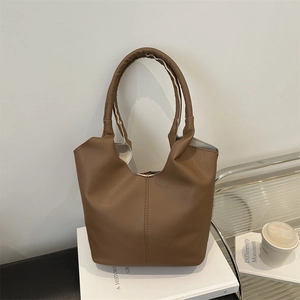 Brown lychee pattern bucket bag with integrated top handle and minimalist stitching