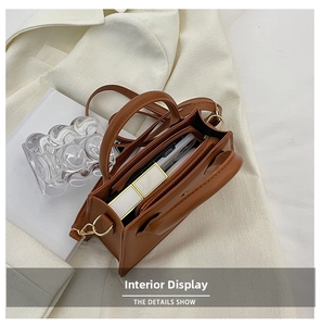 Internal view of brown leather bag showing spacious storage with zipper compartment