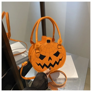Detail of pumpkin crossbody bag with black spider web texture and spooky face design