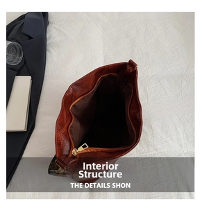 Top-view of dark brown tote bag interior featuring spacious lining and secure zipper