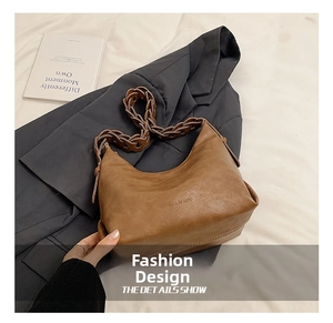 Detail show of brown PU leather hobo bag with a unique woven strap and brand embossing
