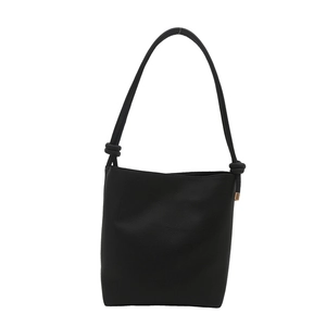 Minimalist black pebble leather bucket crossbody bag with knot strap and gold hardware