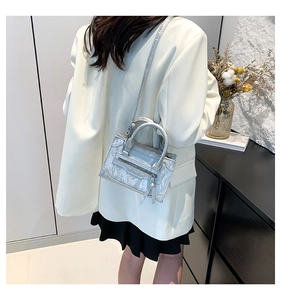 Detail showing the silver faux snake texture and zipper element of the mini square handbag