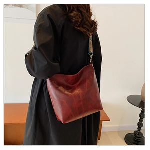 Detailed patchwork leather tote in wine red with a vintage ethnic print wide strap