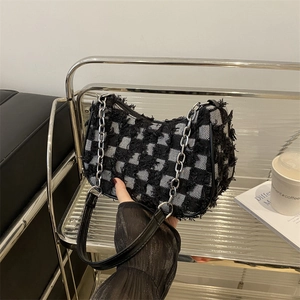 French denim checkerboard baguette shoulder bag with frayed edges and silver chain strap