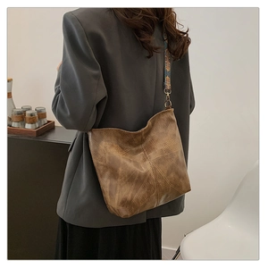 Brown vintage large shoulder bag with geometric stitching and ethnic print strap