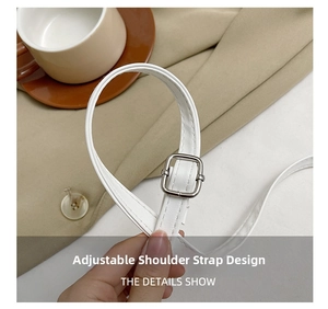 Detail of adjustable white leather shoulder strap with silver buckle and fine stitching