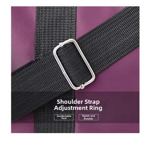 Close-up of adjustable black nylon strap with silver metal buckle on purple travel bag