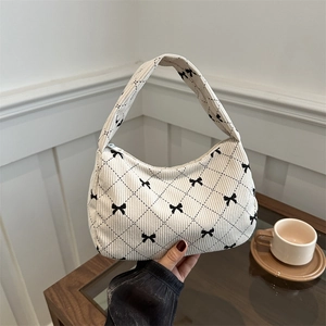 Chic cream corduroy shoulder bag with black diamond pattern and decorative bows