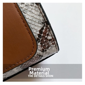 Close-up of brown leather and snakeskin texture patchwork with fine stitching details