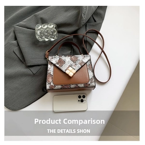 Detailed view of bicolor crossbody bag with snakeskin panel and gold floral lock clasp