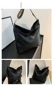 Detail of black faux leather hobo bag with crocodile pattern and colorful ethnic strap