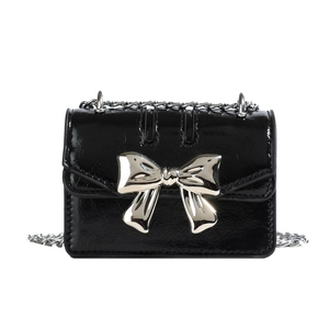 Mini black patent leather crossbody bag with silver butterfly metal detail and chain strap