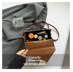Interior view of brown faux leather shoulder bag showing storage for phone and cosmetics