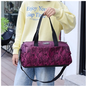 Detail of purple camo travel bag with durable black handles and adjustable shoulder strap