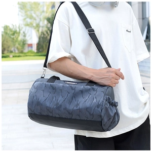 Detail of camouflage travel bag featuring side drawstring pocket for water bottle or umbrella