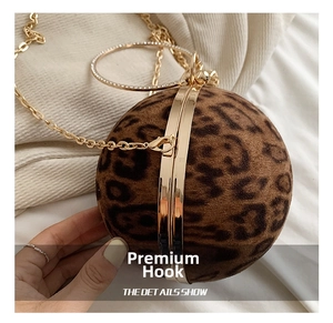 Close-up of leopard print heart bag with gold circular handle and diamond accents