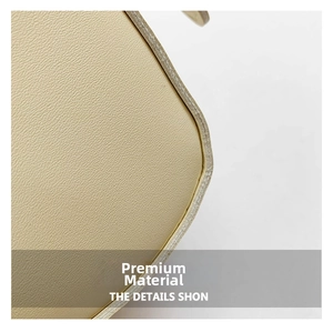 Close-up detail of cream textured leather stitching and refined edge of the shoulder bag