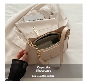 Detail of the multi-compartment interior space of this beige leather shoulder bag