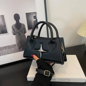 Minimalist black leather square handbag with silver star detail and crossbody strap