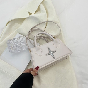 Minimalist beige trapezoid handbag with silver star detail and adjustable strap