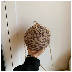 Detailed close-up of leopard print spherical handbag with rhinestone circular metal handles