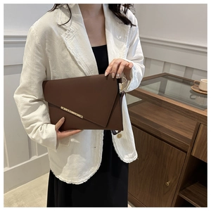 Minimalist dark brown leather envelope clutch bag with gold bar detail and metal ring