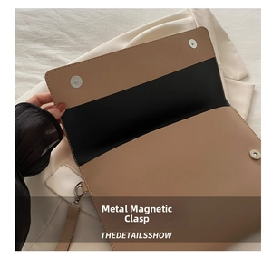 Detail view of the secure magnetic metal snap closures and inner lining of the handbag