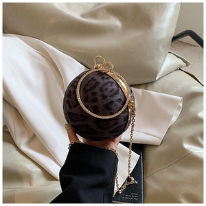 Detail of leopard print ball evening bag with a sparkling rhinestone metal ring handle