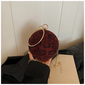 Detail of spherical leopard print bag with rhinestone gold handle and metal chain strap