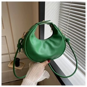 Fashionable bright green crescent moon hobo bag with unique knot detail and gold hardware