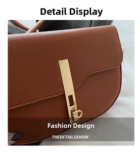 Close-up of brown litchi pattern leather shoulder bag with sleek gold bar metal lock