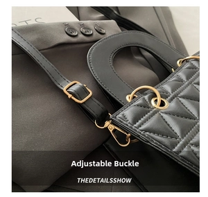 Close-up of golden adjustment buckle and quilted leather texture on a black handbag