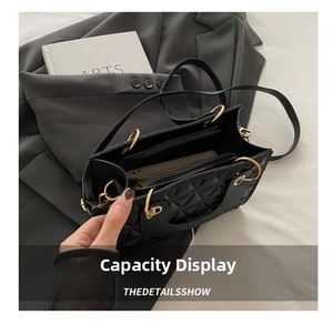 Detail showing the large interior capacity and golden hardware of a black quilted bag