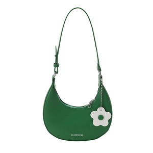 Minimalist emerald green crescent shoulder bag with white floral pendant detail