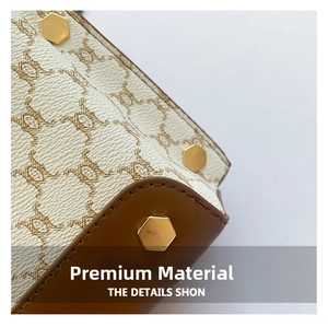 Detailed macro view of reinforced leather corners and gold-tone metal studs on bag base