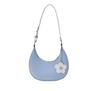 Light blue crescent shoulder bag with white flower charm and minimalist design