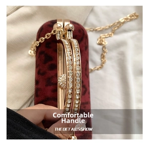 Detailed close-up of dark red leopard print velvet bag with crystal-encrusted gold handles