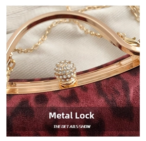 Macro view of gold clasp with inlaid rhinestones on leopard print suede handbag