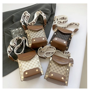 Detail view of retro plaid crossbody bags with wide jacquard straps in four colors
