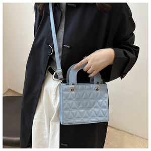 Light blue quilted handbag with triangular pattern and golden hardware for women