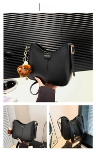 Detail of black matte PU leather bucket bag with gold lettering and plush charm pendant