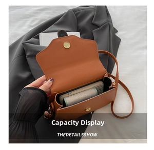 Interior view of the vintage leather shoulder bag showing storage for phone and wallet
