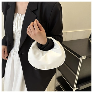 Detail of white crescent handbag with smooth matte leather and light gold metal zipper