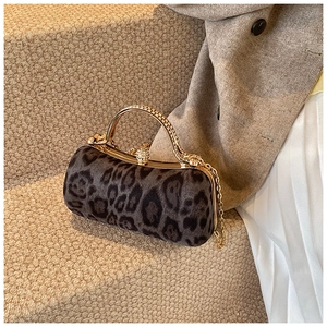Detail of leopard print evening bag with rhinestone metal handle and gold ball lock